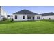 Large backyard with green grass and a home with covered patio at 680 Blackthorne Circle Nw, Calabash, NC 28467
