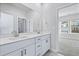 Double vanity bathroom with white cabinets and a mirror at 680 Blackthorne Circle Nw, Calabash, NC 28467