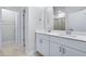 Double vanity bathroom with white cabinets and a large mirror at 680 Blackthorne Circle Nw, Calabash, NC 28467