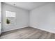 Spacious bedroom with wood-look floors and a window at 680 Blackthorne Circle Nw, Calabash, NC 28467