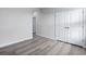 Bright bedroom featuring wood-look floors and a double door closet at 680 Blackthorne Circle Nw, Calabash, NC 28467