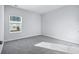 Simple bedroom with grey carpet and a window at 680 Blackthorne Circle Nw, Calabash, NC 28467
