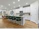 Modern kitchen with white cabinets, stainless steel appliances, and an island with seating at 680 Blackthorne Circle Nw, Calabash, NC 28467