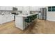 Kitchen island with white quartz countertops and green velvet stools at 680 Blackthorne Circle Nw, Calabash, NC 28467