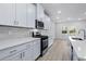 Modern kitchen with white cabinets, quartz countertops, and stainless steel appliances at 680 Blackthorne Circle Nw, Calabash, NC 28467