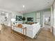 Light and airy living room with a sectional sofa and access to a bedroom at 680 Blackthorne Circle Nw, Calabash, NC 28467