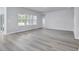 Open living space with vinyl flooring and access to the kitchen at 680 Blackthorne Circle Nw, Calabash, NC 28467