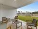 Covered patio with seating and views of the surrounding landscape at 680 Blackthorne Circle Nw, Calabash, NC 28467