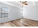 Well-lit bedroom with wood-look floors and ceiling fan at 481 Irees Way, Longs, SC 29568