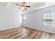 Light-filled bedroom featuring wood-look floors and ceiling fan at 481 Irees Way, Longs, SC 29568