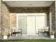 Relaxing patio with rocking chairs and stone facade at 110 South Shore Blvd. # 103, Longs, SC 29568