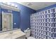 Clean bathroom with shower/tub combo and gray vanity at 8546 Hopkins Circle # G, Surfside Beach, SC 29575