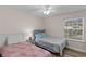 Bedroom with two twin beds, window and ceiling fan at 8546 Hopkins Circle # G, Surfside Beach, SC 29575