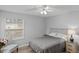 Cozy bedroom with a queen-size bed, nightstand, and ceiling fan at 8546 Hopkins Circle # G, Surfside Beach, SC 29575