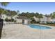 Kidney shaped community pool with a pool house and surrounding fence at 8546 Hopkins Circle # G, Surfside Beach, SC 29575