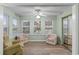 Relaxing sunroom with two armchairs and a view of the community at 8546 Hopkins Circle # G, Surfside Beach, SC 29575