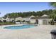 Community pool with surrounding patio and building at 8546 Hopkins Circle # G, Surfside Beach, SC 29575