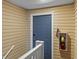 Hallway with a blue door and fire extinguisher at 8546 Hopkins Circle # G, Surfside Beach, SC 29575