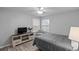 Bright bedroom with a queen-size bed, media console and ceiling fan at 8546 Hopkins Circle # G, Surfside Beach, SC 29575