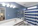 Bathroom with blue walls, striped shower curtain and a single vanity at 8546 Hopkins Circle # G, Surfside Beach, SC 29575