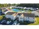 Aerial view of an apartment complex with a pond and pool at 8546 Hopkins Circle # G, Surfside Beach, SC 29575
