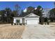 Newly built home with gray siding, two-car garage, and landscaping at 7068 Shady Grove Rd., Conway, SC 29527