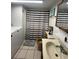 Bathroom with toilet, sink, and shower with striped curtain at 848 S Waccamaw Dr., Garden City Beach, SC 29576