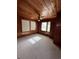 Well-lit bedroom with wood paneled walls and carpet flooring at 848 S Waccamaw Dr., Garden City Beach, SC 29576