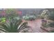 Lush backyard garden with brick patio, various plants, and flowers at 2808 Stellar Loop, Myrtle Beach, SC 29577