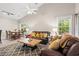 Open living room with brown leather couches, coffee table, and view into dining area at 1025 Algonquin Dr. # 15-E, Pawleys Island, SC 29585