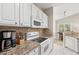 White kitchen cabinets, granite countertops, and appliances at 1025 Algonquin Dr. # 15-E, Pawleys Island, SC 29585