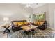Living room featuring a brown leather sofa, coffee table and a ceiling fan at 1025 Algonquin Dr. # 15-E, Pawleys Island, SC 29585