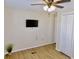 Bright bedroom featuring wood-look floors and a mounted television at 1107 Blue Ridge Trail, North Myrtle Beach, SC 29582