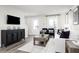 Living room features a white couch, black accent chairs, and a large TV at 2740 Rowyn St., Longs, SC 29568