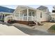 Cute beach cottage with white porch and golf cart at 6001 South Kings Hwy., Myrtle Beach, SC 29575