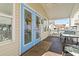 Inviting front porch with seating and blue doors at 6001 South Kings Hwy., Myrtle Beach, SC 29575