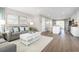 Open concept kitchen and living area with white cabinets, stainless steel appliances, and hardwood floors at 2748 Rowyn St., Longs, SC 29568