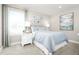 Cozy bedroom with light blue bedding, white nightstand, and large framed artwork at 2748 Rowyn St., Longs, SC 29568