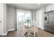 Bright breakfast nook with glass table and four chairs, adjacent to kitchen and sliding door at 2748 Rowyn St., Longs, SC 29568