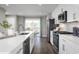 Modern kitchen with white cabinets, island, and stainless steel appliances at 2748 Rowyn St., Longs, SC 29568