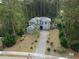 Aerial view of a luxurious two-story house with a spacious driveway and lush landscaping at 1065 Wigeon Dr., Conway, SC 29526