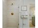 Walk-in shower with beige tile and gold fixtures at 8479 Duke Pl. # 34, Myrtle Beach, SC 29572