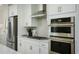 Modern kitchen with stainless steel appliances and white cabinets at 8481 Duke Pl. # 35, Myrtle Beach, SC 29572