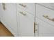 White kitchen cabinets with gold hardware, offering a clean and stylish look at 8483 Duke Pl. # 36, Myrtle Beach, SC 29572