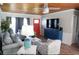 Living room with gray sofas, wood-paneled ceiling, and large TV at 309 21St Ave. N, North Myrtle Beach, SC 29582