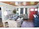 Living room with gray sofas, wood-paneled ceiling, and large TV at 309 21St Ave. N, North Myrtle Beach, SC 29582