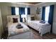 Twin bedroom with white beds and blue curtains at 309 21St Ave. N, North Myrtle Beach, SC 29582