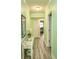 Light and airy hallway with light green walls and wood-look flooring at 100 North Beach Blvd. # 311, North Myrtle Beach, SC 29582