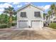 Gray two-story house with two-car garage and palm trees at 1125 Camellia Dr., Surfside Beach, SC 29575