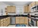 L-shaped kitchen with granite countertops and light cabinets at 1125 Camellia Dr., Surfside Beach, SC 29575